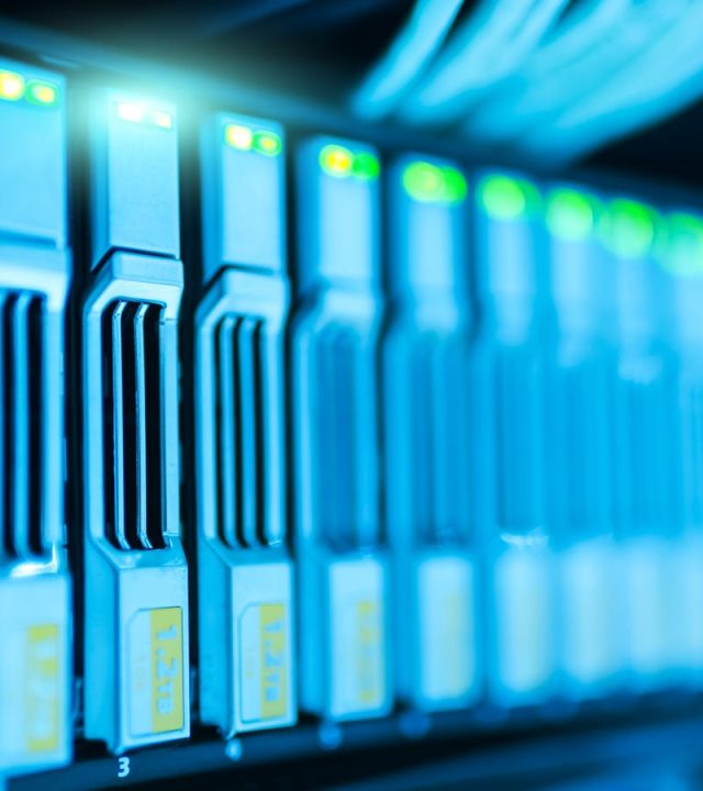 Detailed image of a server rack with glowing lights in a modern data center.